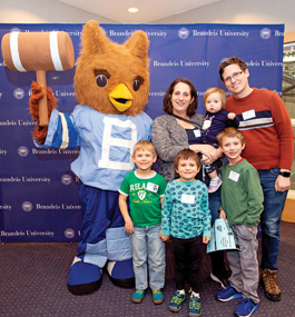 Parents and four small children with Brandeis mascot Ollie